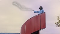 a man standing on top of a red railing with a lightning bolt